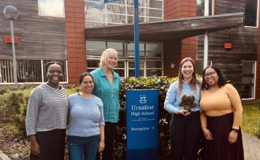 King's CRF staff standing in front of a sign which says 'Ursuline High School'
