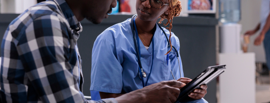 patient and nurse with tablet in waiting room