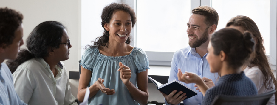 Happy diverse people sitting on chairs in circle, talking stock photo