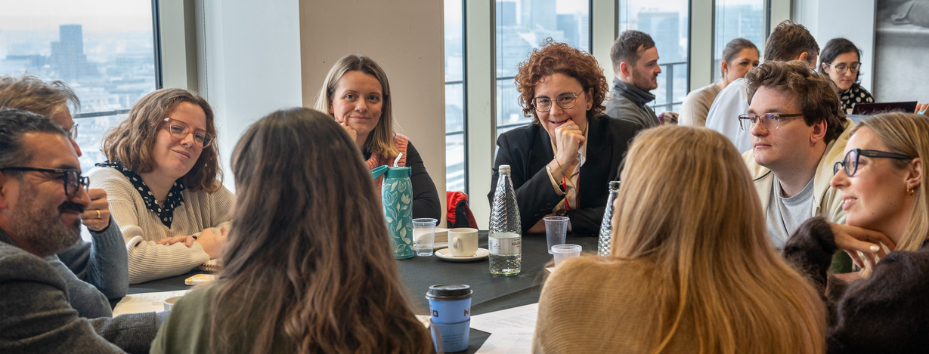 group of people at a table talking to each other